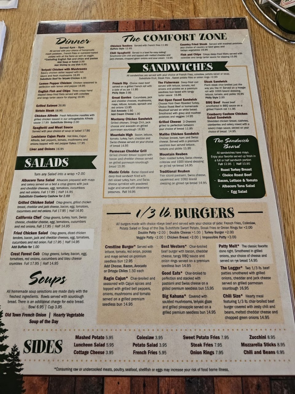 Coffee and diner breakfast beside a menu board.